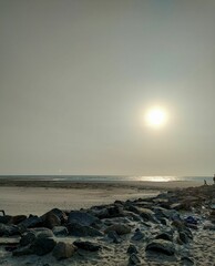 Canvas Print - a rocky beach near the water at sunset