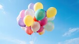 Fototapeta Nowy Jork - Colorful balloons float on the blue sky background