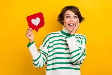 Poster - Photo of sweet shocked lady wear striped pullover arm hand cheek cheekbone rising heart like card isolated yellow color background