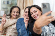 © Cultura Creative - Family portrait with down syndrome woman taking selfie at home