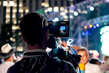 Camera Man Recording Television Reporter At Live Event