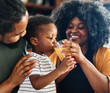 © Lumos sp - child family kitchen boy son mother father drink breakfast juice healthy fruit food drinking thirsty eating glass home black african american childhood cute love bonding