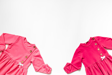 Kids wear flat lay - pink girls dress. Baby fashion concept