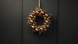  a gold christmas ornament hangs on a black door with a gold wreath hanging on the side of the door.  generative ai