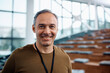 © Drazen - Happy public speaker during business conference in convention center looking at camera.