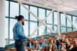 © Drazen - Black businessman talking to group of seminar attendees in conference hall.