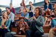 © Drazen - Mature businesswoman using microphone while speaking from audience during seminar.