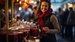 © MP Studio - A smiling woman at an outdoor Christmas fair stand at night, surrounded by warm bokeh lighting