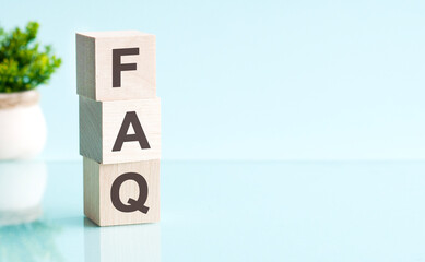 Sticker - FAQ - text on wooden cubes on blue background. business concept.