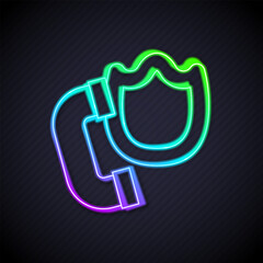 Poster - Glowing neon line Telephone handset with security shield icon isolated on black background. Phone sign. Vector