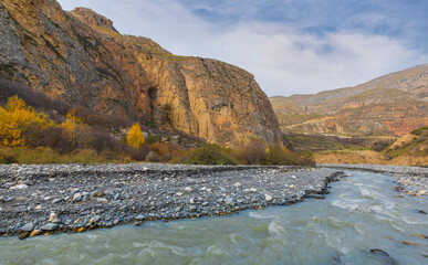 Wall Mural - Stormy mountain river in autumn