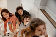 © Marko Geber - Young family with small children going upstairs at home