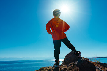 Sticker - Boy standing on top of mountain and looking at the lake