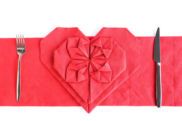 Wall Mural - Red color heart shape napkins on white with cutlery set,top view