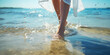 Barefoot womans feet walking with water splashes along the shoreline on beach at sunny day, creating a dynamic and refreshing scene. Themes of summer, relaxation, vacations and the simple joys of life