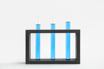 Wall Mural - Test tubes with samples in stand on grey background