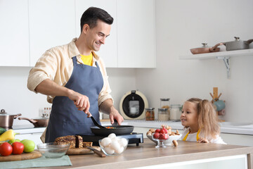 Poster - Cute little girl with her dad cooking in kitchen