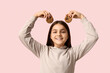 © Pixel-Shot - Happy little girl holding sweet chocolate cookies on pink background