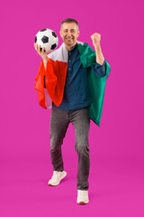 Wall Mural - Mature man with Mexican flag and soccer ball on purple background