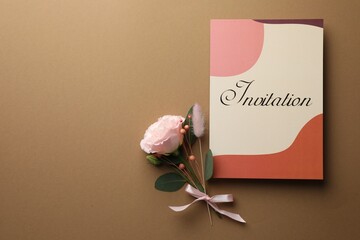 Wall Mural - Card with word Invitation and beautiful flowers on beige background, flat lay. Space for text