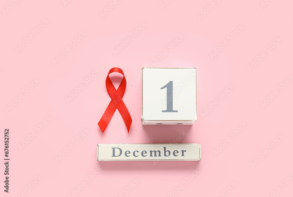 Red ribbon with calendar on pink background. AIDS Day concept