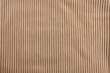 Tan corduroy fabric, closeup of surface material texture