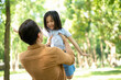 Photo of Asian father and daughter at park