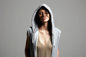 Wall Mural - beautiful young woman in hood. girl in grey hoodie