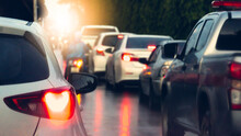 Abstract Of White Car Taillights Illuminate With Bright Of Brake Lights. Casting A Glow Through The Mist Of Scattered Rain. Traffic Is Congested During The Rainy Period. With Cars Queued In Line.