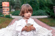 little boy in a city park dressed as an angel