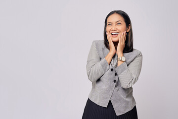 Wall Mural - Excited young Asian woman in casual clothes touching cheek with hand, reacting to offering discount isolated on white background. People lifestyle concept