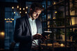© alisaaa - Shot of a handsome young businessman using a digital tablet while working late in his office