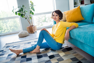 Poster - Portrait of lovely cheerful girl wear trendy clothes sitting on carpet enjoying weekend comfort modern loft flat indoor