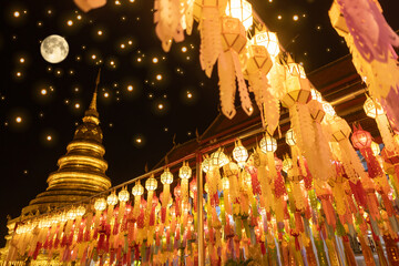 Sticker - Lantern Festival in Lamphun people hang colorful light lanterns at Wat Phra That Hariphunchai Temple full moon
