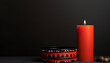 National Day for Truth and Reconciliation background with red candle in front of black backdrop with copy space.