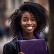 Smiling black female college student on college campus in fall, back to school, ready to start school year