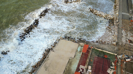 Wall Mural - Storm in Marina di Pisa, Tuscany. Fury of the waves on the coast, aerial view on a sunny morning