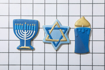 Wall Mural - Gingerbread cookies with Jewish symbols on light background, top view