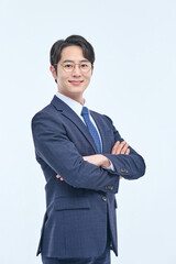 A young and handsome Asian man in a suit is wearing glasses and making various facial expressions and hand gestures.