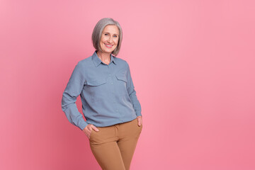 Sticker - Portrait of confident cheerful person with gray short hair wear stylish shirt standing hold arms in pockets isolated on pink background