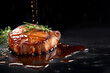 Juicy Porkchop steak with rosemary and spices isolated on a black background with copy space, Grilled beef steak, Delicious food menu, Closeup