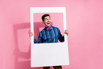 Canvas Print - Portrait of classy astonished guy arms hold paper album card look empty space isolated on pink color background