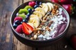 Healthy breakfast bowl with acai, fruits, and seeds.