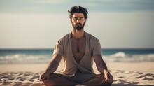 A Man Sitting In A Yoga Pose On The Beach. Yoga Meditation Outdoors.