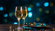 Coupes de champagne et bouteille, célébration et fête. Couleurs bleu, doré, noir. Ambiance festive, nouvel an, anniversaire. Espace vide pour conception et création graphique.