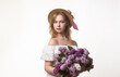 © ostapenkonat - A young, beautiful girl with a large bouquet of lilacs. Vintage style.