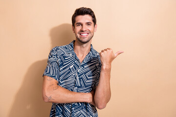 Poster - Photo of nice cheerful man dressed trendy clothes arm direct billboard empty space black friday adv isolated on beige color background