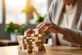 Fototapeta  - Faceless elderly woman with dementia playing with wooden blocks in geriatric clinic or nursing home close-up