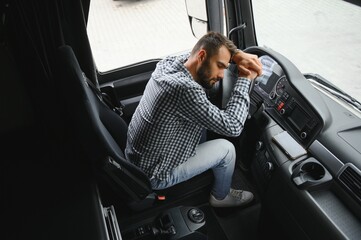 Man trucker tired driving in a cabin of his truck