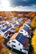 Eco-friendly apartment buildings with solar panels on roofs surrounded by autumn trees. Apartment buildings with environmentally friendly large batteries on rooftops on edge of multi-colored trees